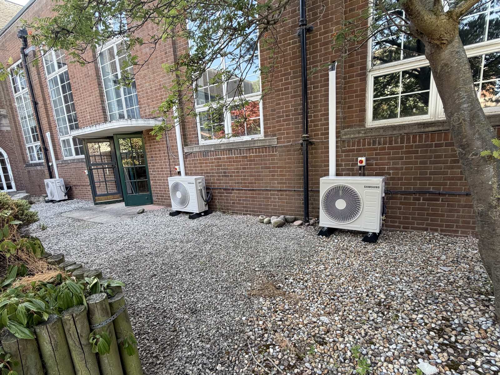 Three Samsung outdoor units in a school courtyard