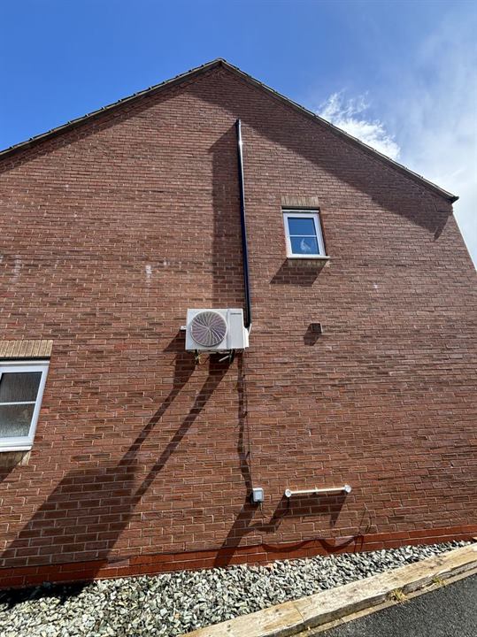 Samsung outdoor unit with concealed pipework on a gable wall