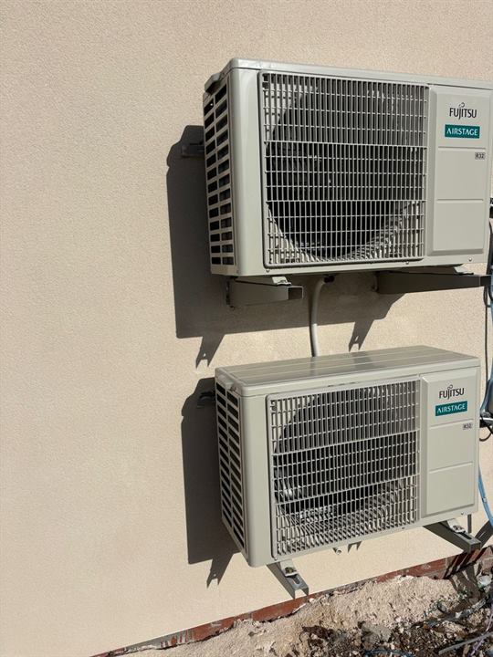 Two Fujitsu Airstage outdoor condenser units